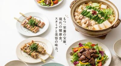 温かい鍋料理、串焼き、レバーサラダが並ぶ和食の食卓